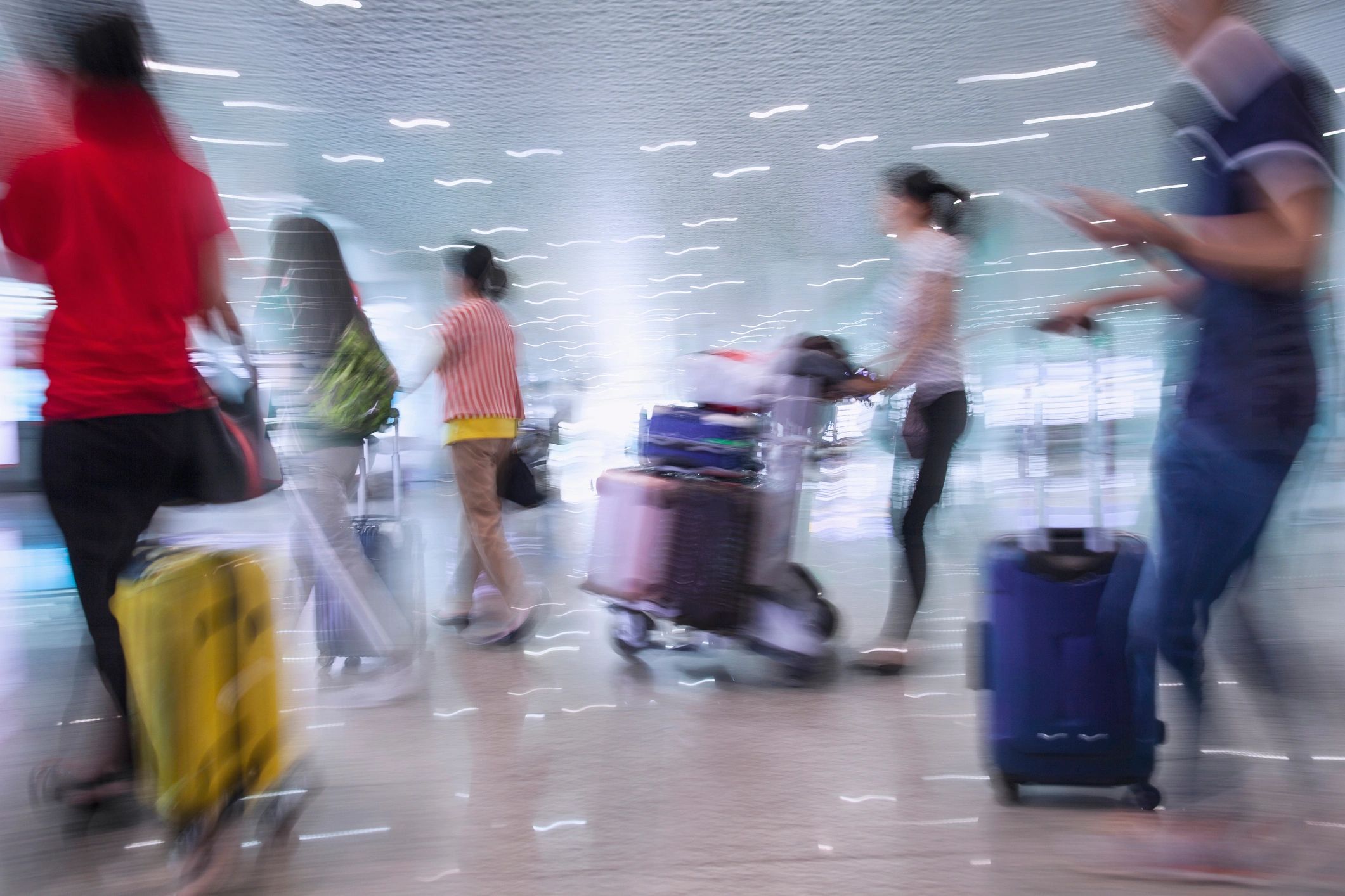 Passengers moving through an airport terminal